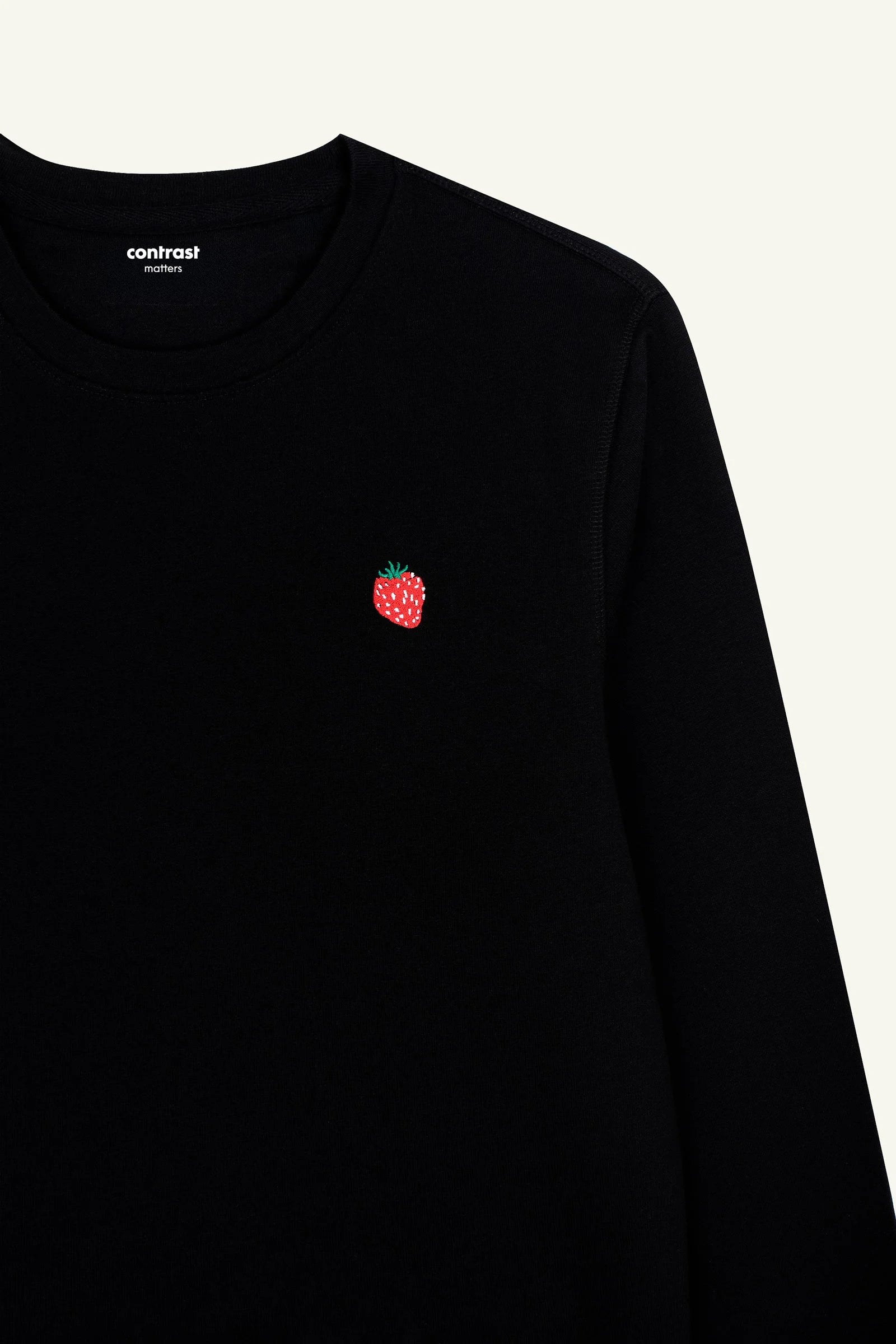 Black organic cotton sweatshirt with strawberry embroidery, soft and sustainable fabric.