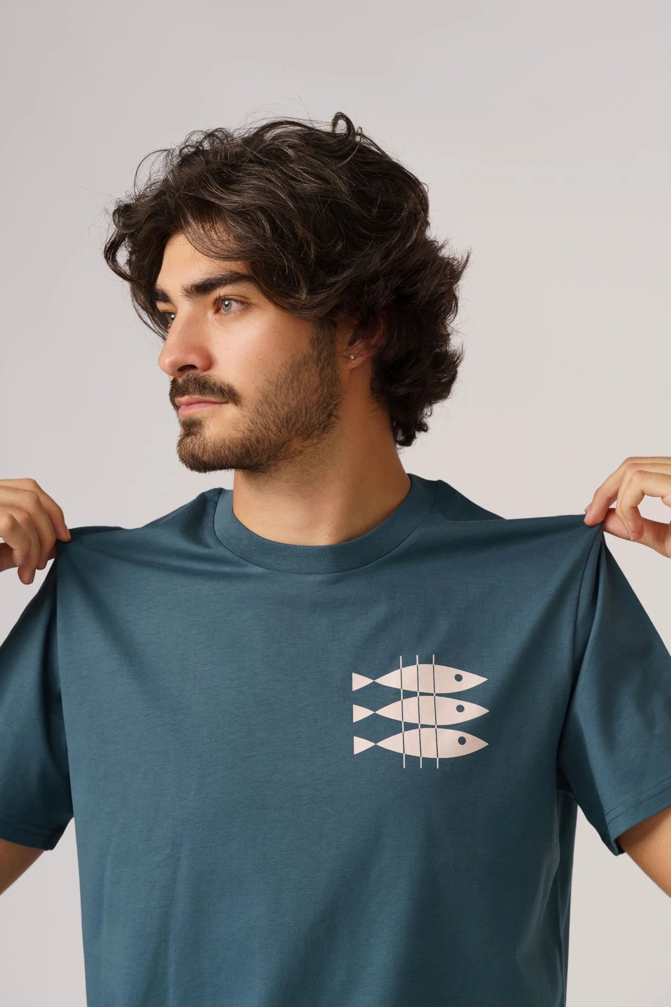 Contrast designer graphic tees collection featuring Sardines organic t-shirt in Stargazer Green.