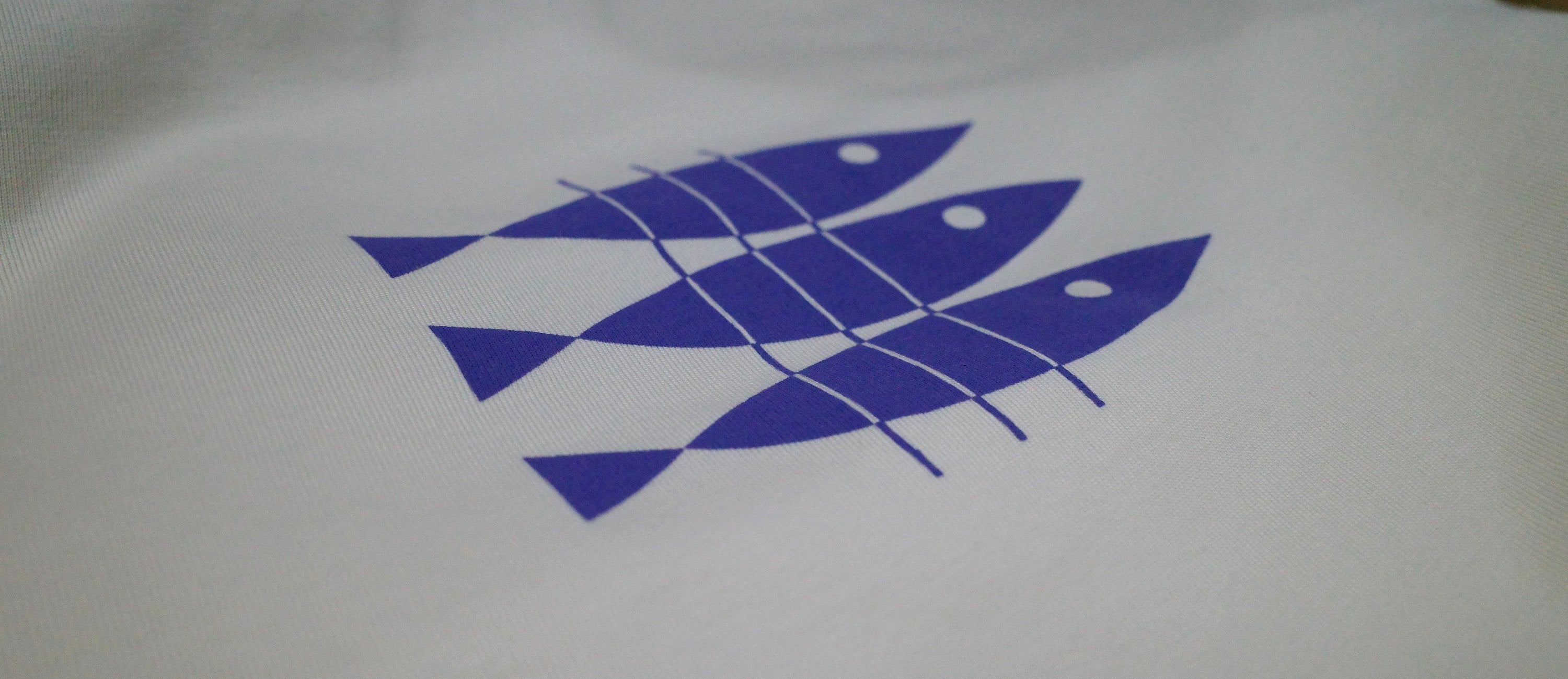 Three hand-drawn sardines screen printed in blue on an organic cotton Contrast t-shirt