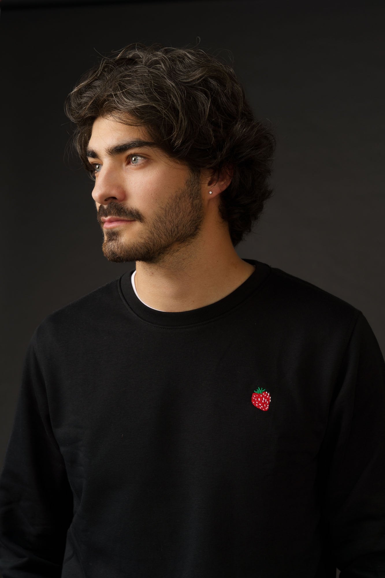 Organic cotton sweatshirt with small strawberry embroidery, minimal unisex design.
