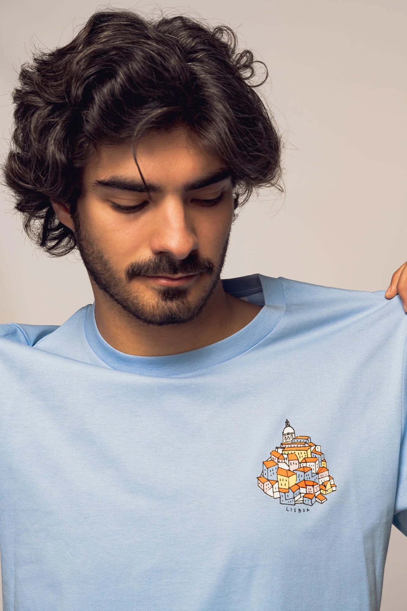 Contrast designer graphic tees collection featuring Alfama Hill organic tee shirts in Blue Soul shade.